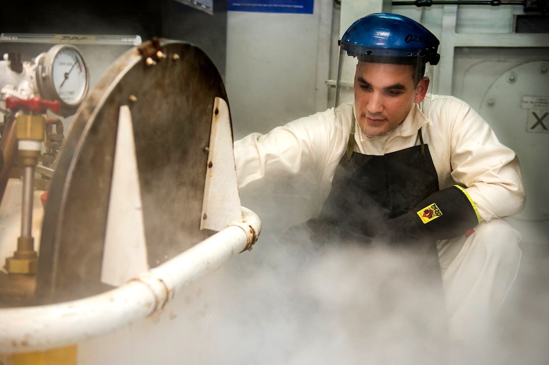 Navy Petty Officer 1st Class Caesare Reyes checks the pressure of a liquid oxygen cart aboard the aircraft carrier USS Carl Vinson in the South China Sea, Feb. 21, 2017. Reyes is a machinist’s mate. Navy photo by Petty Officer 2nd Class Sean M. Castellano