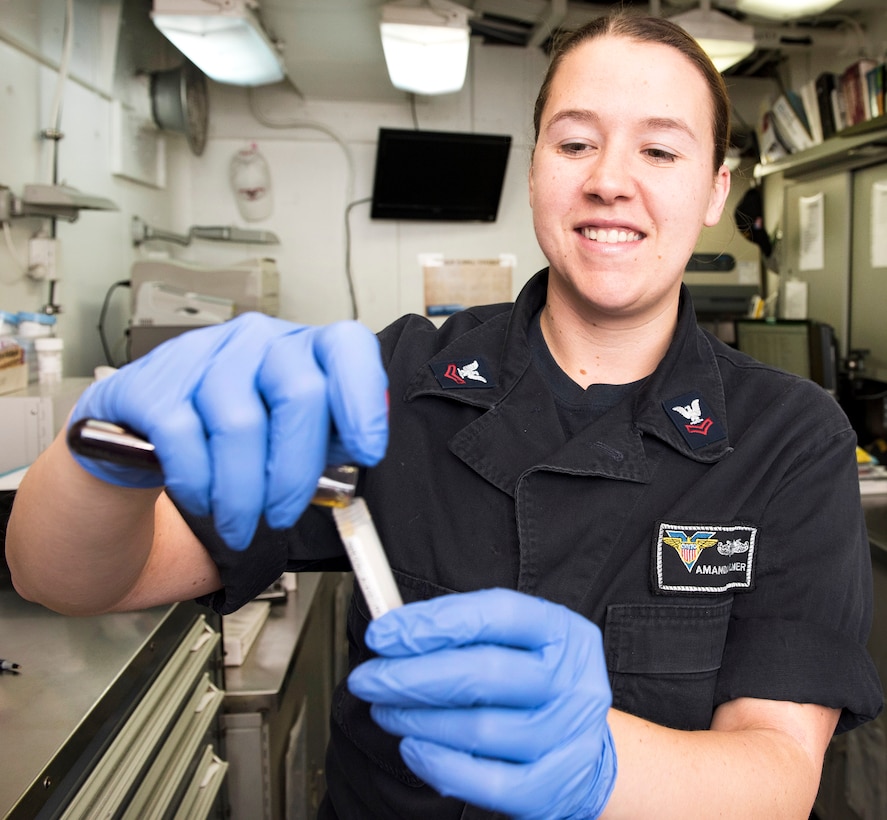 Navy Petty Officer 2nd Class Amanda Palmer prepares a blood sample for testing in the blood lab aboard the aircraft carrier USS Carl Vinson in the South China Sea, Feb. 21, 2017. Palmer is a hospital corpsman. Navy photo by Petty Officer 3rd Class Matt Brown