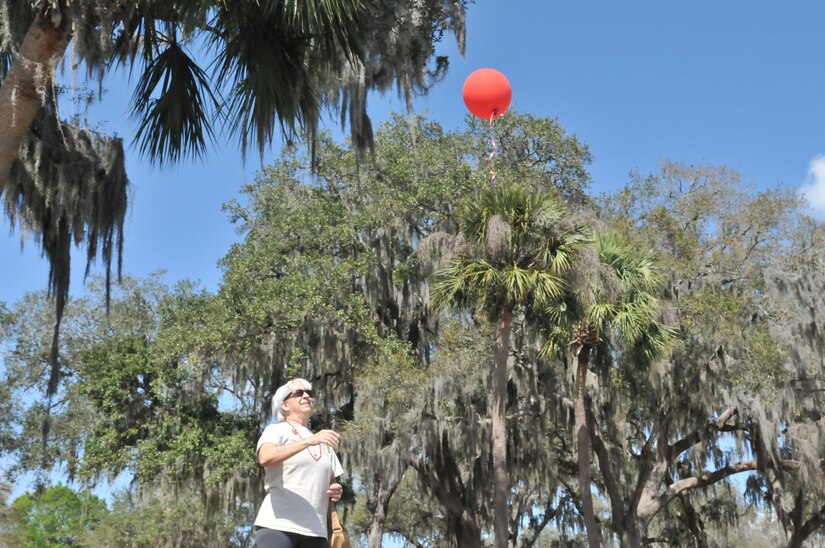 Michele Carey, Gold Star Mother of Cpl. Bart Humlhanz, releases a balloon for her fallen Marine.  Carey wrote her note and attached it to the balloon to send up to her son in the heavens.  This activity is part of Operation Love Letters, which  is an annual patriotic celebration to honor fallen service members through fellowship with family and friends gathered together writing love letters, scripting poetry, sharing loveable memories of their service member, and enjoying the offerings of some very special guests. This year, the event was held at Veterans Memorial Park in Tampa on Feb. 19, 2017.