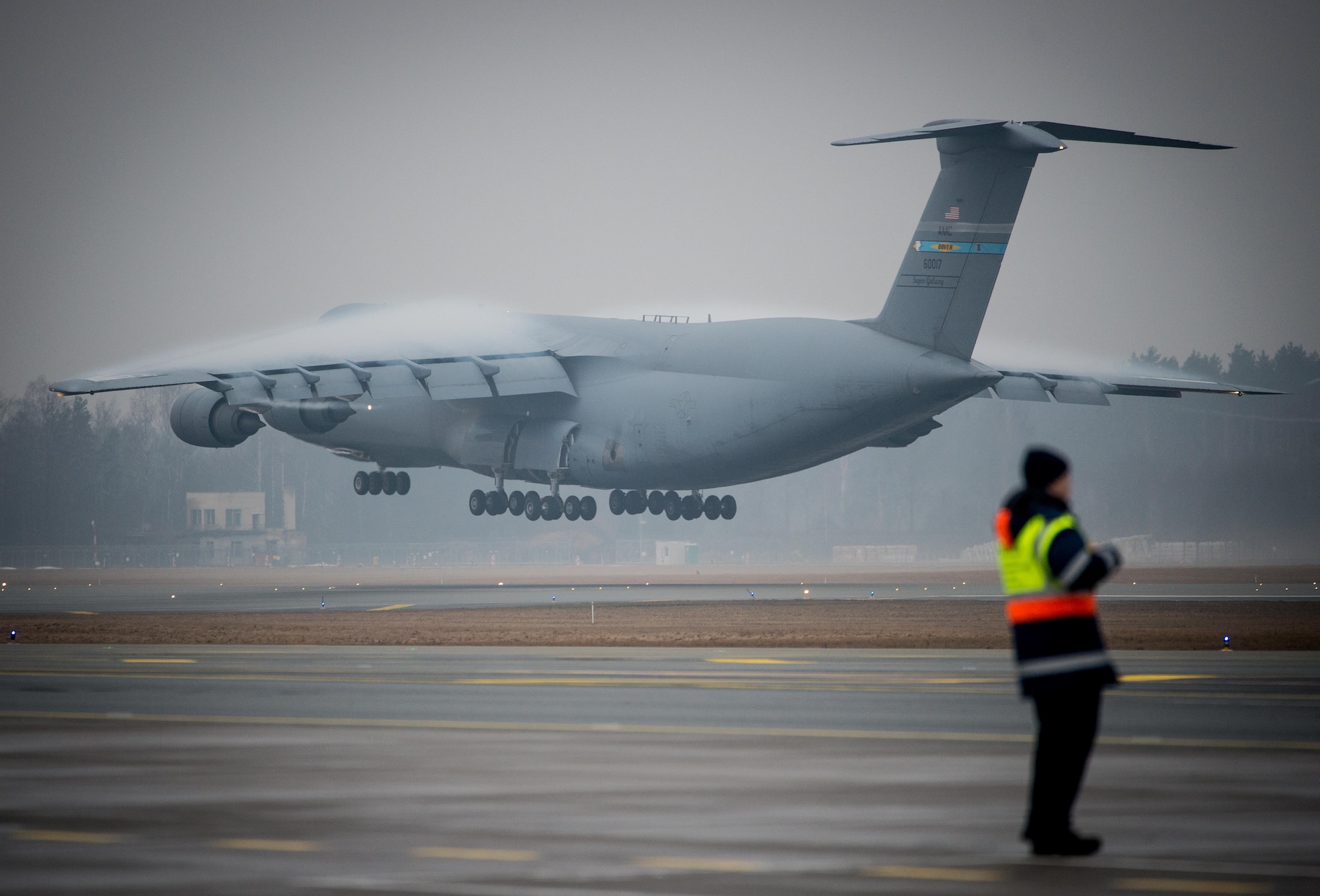 An Air Mobility Command C-5M Super Galaxy lands at Riga International Airport, Latvia, Mar. 1, 2017, to deliver UH-60 Black Hawk helicopters for the U.S. Army in support of Operation Atlantic Resolve. Five Black Hawk helicopters will be deployed to Latvia as part of a larger contingent of helicopters and personnel deployed to support Operation Atlantic Resolve, a U.S. commitment to maintaining peace and stability in the European region. (U.S. Air Force photo/Tech. Sgt. Ryan Crane)