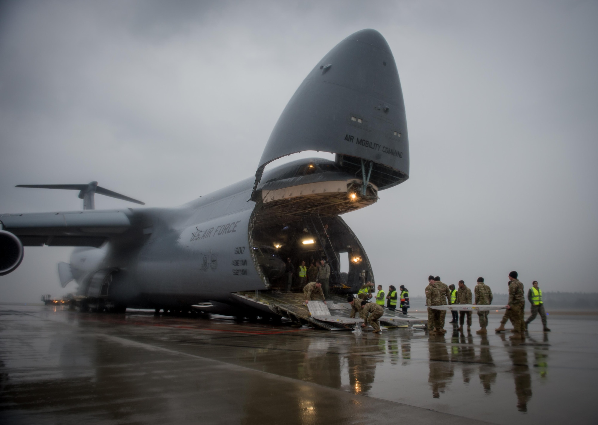 A U.S. Army UH-60 Black Hawk helicopter is unloaded from an Air Mobility Command C-5M Super Galaxy at Riga International Airport, Latvia, Mar. 1, 2017. Five Black Hawk helicopters will be deployed to Latvia as part of a larger contingent of helicopters and personnel deployed to support Operation Atlantic Resolve, a U.S. commitment to maintaining peace and stability in the European region. (U.S. Air Force photo/Tech. Sgt. Ryan Crane)