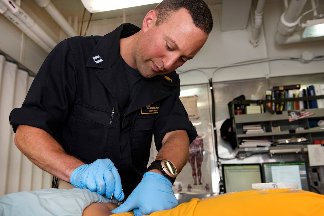 Navy Lt. Stetson Schmitt performs trigger point dry needling on a patient aboard the aircraft carrier USS Carl Vinson in the South China Sea, Feb. 21, 2017. Schmitt is a physical therapist. Navy photo by Petty Officer 3rd Class Matt Brown 