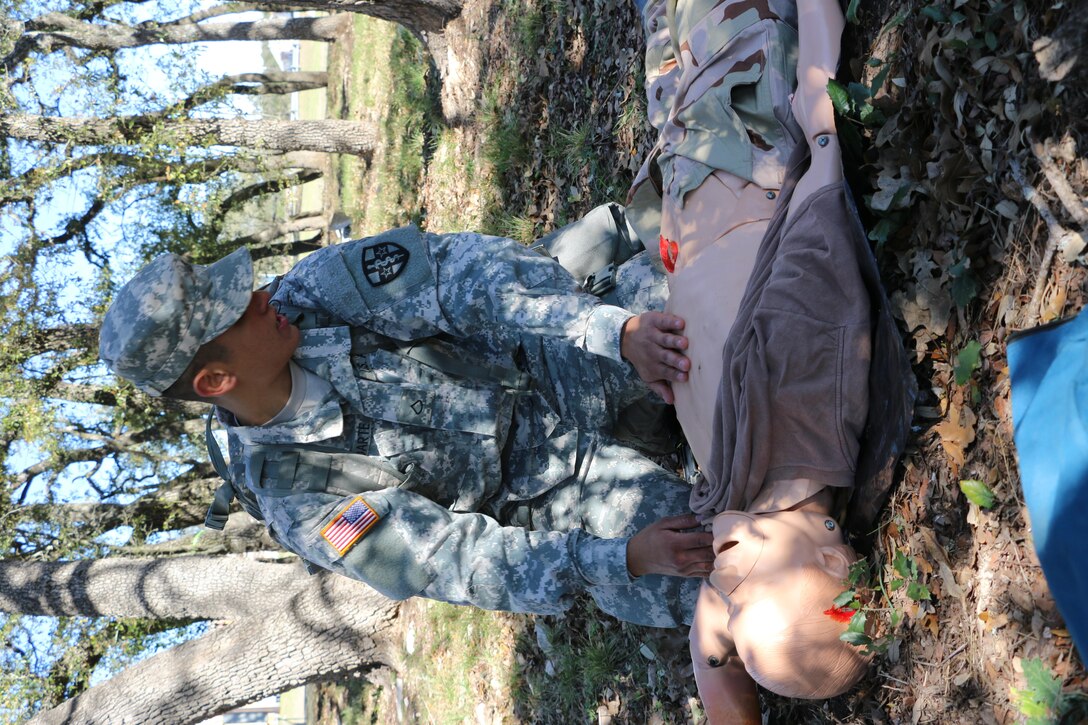Spc. Alec Rodarte, Central Medical Area Readiness Support Group, evaluates a simulated casualty during the Best Warrior Competition at Camp Bullis, Texas, 9 Feb.  Soldiers from the Medical Readiness and Training Command, Northeast MARSG, Southeast MARSG, Central MARSG and Western MARSG competed in the Best Warrior Competition for their respective commands at Camp Bullis, Texas, 8-12 Feb., 2017. 