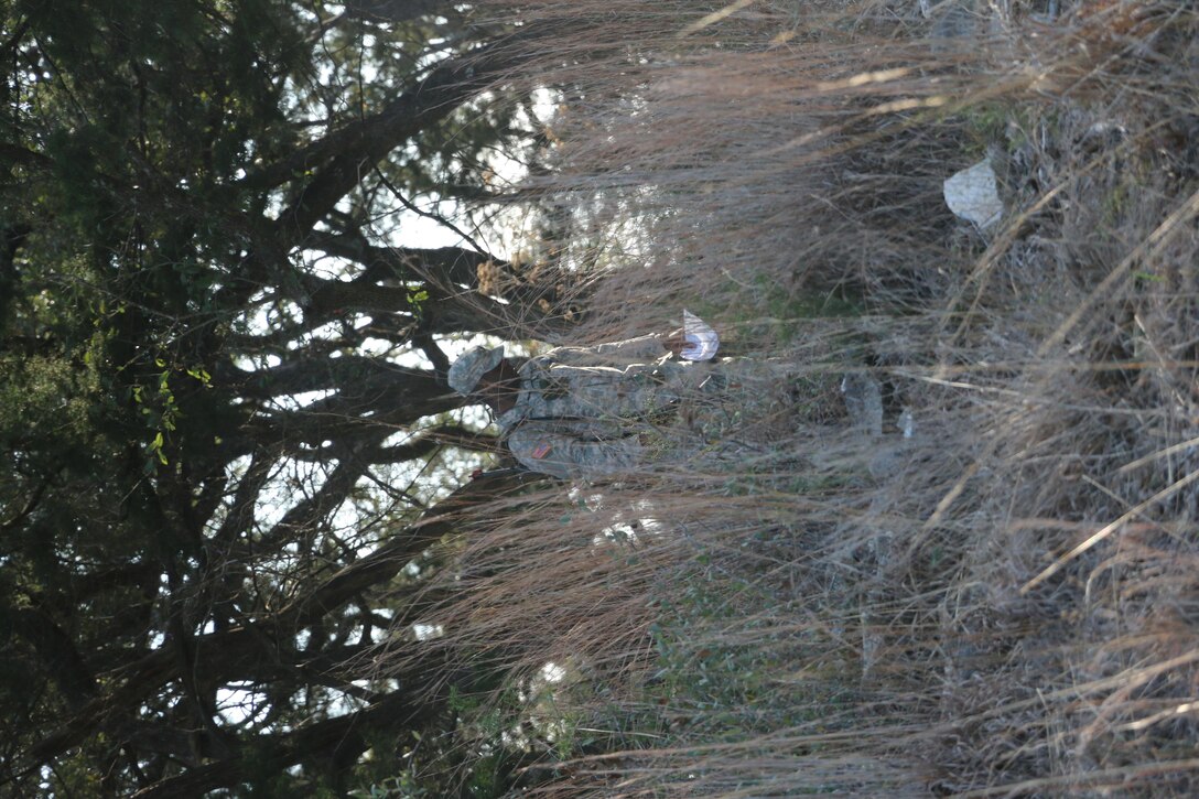 Spc. Germaine Daniels, Western Medical Area Readiness Support Group, searches the ground for a lost compass during daytime land navigation event of the Best Warrior Competition at Camp Bullis, Texas, 10 Feb.  Soldiers from the Medical Readiness and Training Command, Northeast MARSG, Southeast MARSG, Central MARSG and Western MARSG competed in the Best Warrior Competition for their respective commands at Camp Bullis, Texas, 8-12 Feb., 2017. 