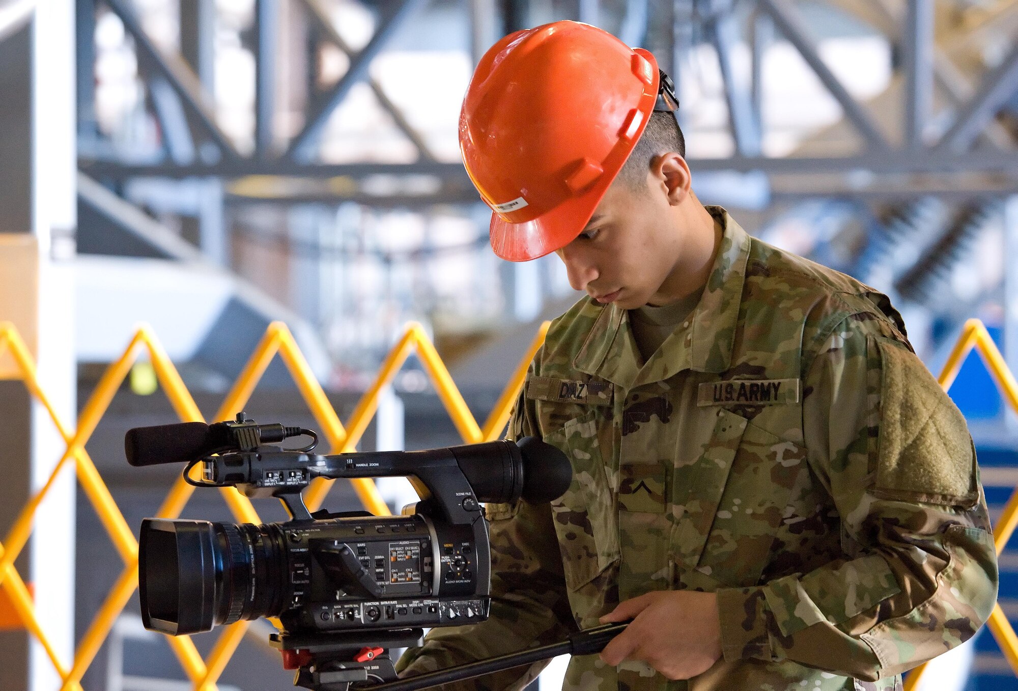 Army Pvt. Jay Diaz, a student from the Defense Information School, Fort Meade, Md., positions his video camera to document maintenance being performed on a C-5M Super Galaxy Feb. 23, 2017, on Dover Air Force Base, Del. Diaz and three other Video Production and Documentation (VPD) students videotaped 436th Maintenance Squadron Isochronal (ISO) Maintenance Dock personnel inspect and perform maintenance on the Super Galaxy during their three-day visit to Dover. (U.S. Air Force photo by Roland Balik)