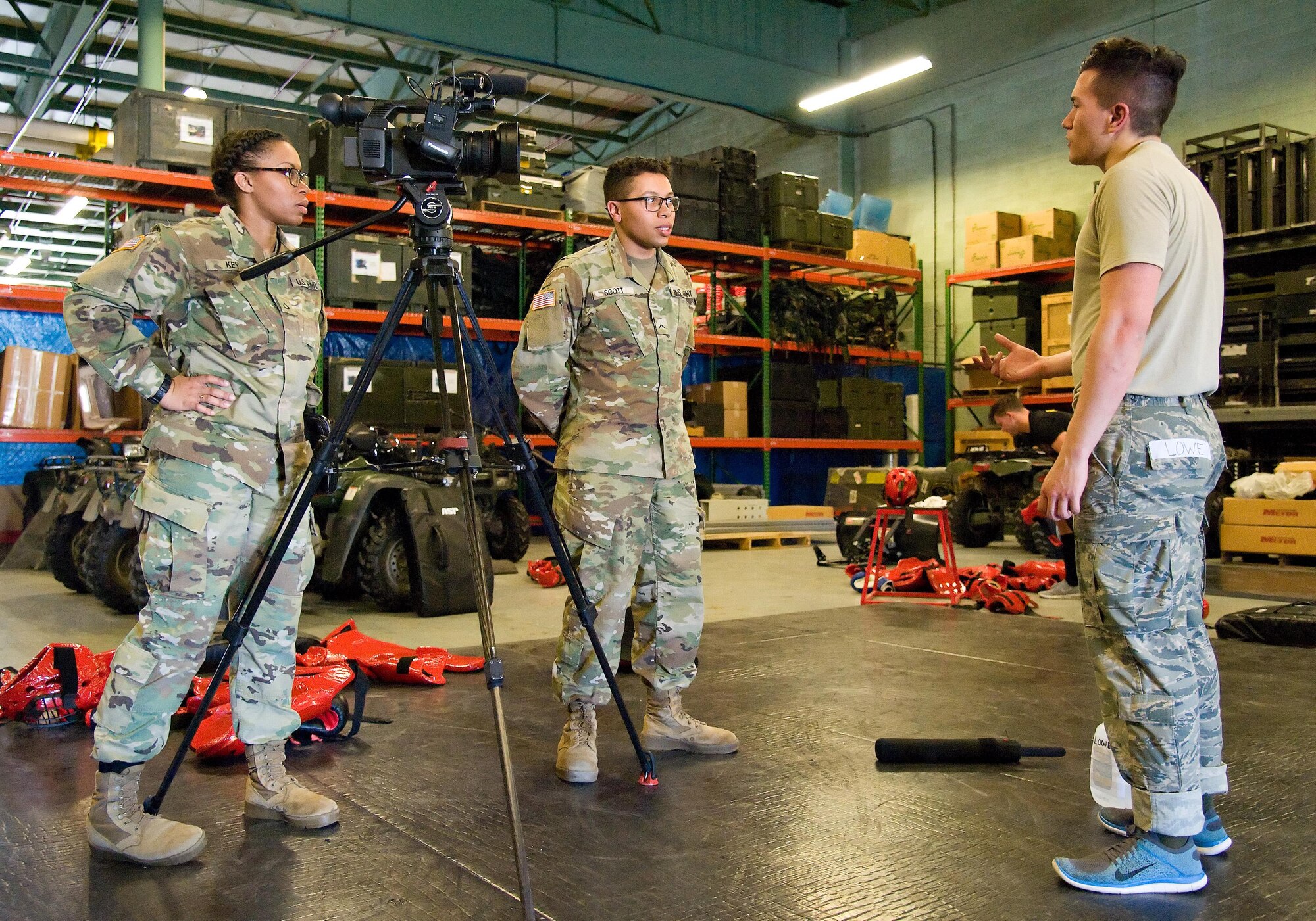 Army Pfc. Keely Key, left and Pvt. Isaiah Scott, center, both Video Production and Documentation (VPD) students from the Defense Information School, Fort Meade, Md., interview Staff Sgt. Andrew Lowe, 436th Security Forces Squadron response force leader, after a Raven’s red man training session Feb. 23, 2017, on Dover Air Force Base, Del. For their final project, sixteen VDP students, 13 Army soldiers and three U.S. Marines, were divided into four teams, came to Dover Feb. 22-25, to document units within the 436th and 512th Airlift Wings, and the 18th Annual Security Forces Ruck March. (U.S. Air Force photo by Roland Balik)