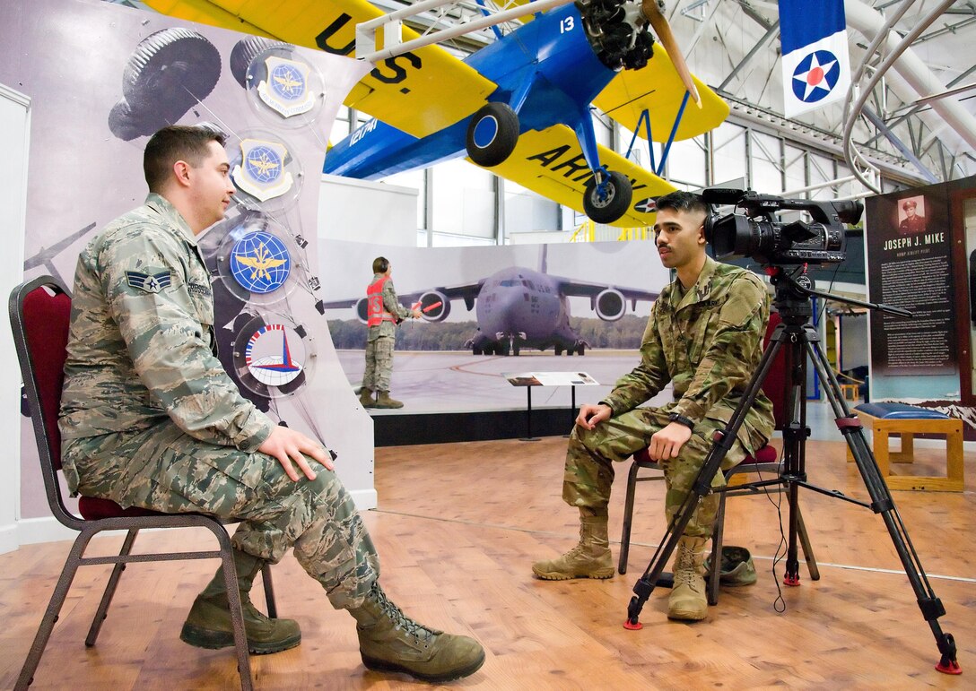 Army Pfc. Anthony Zendejas, IV, a Video Production and Documentation (VPD) student from the Defense Information School, Fort Meade, Md., interviews Senior Airman Matthew Grossenbacher, Air Force Mortuary Affairs Operations dress and restoration specialist, Feb. 25, 2017, at the Air Mobility Command Museum on Dover Air Force Base, Del. Zendejas and three other VDP students on his team chose to document the 18th Annual Security Forces Ruck March as their final project that will account for 60 percent of their final grade. (U.S. Air Force photo by Roland Balik)