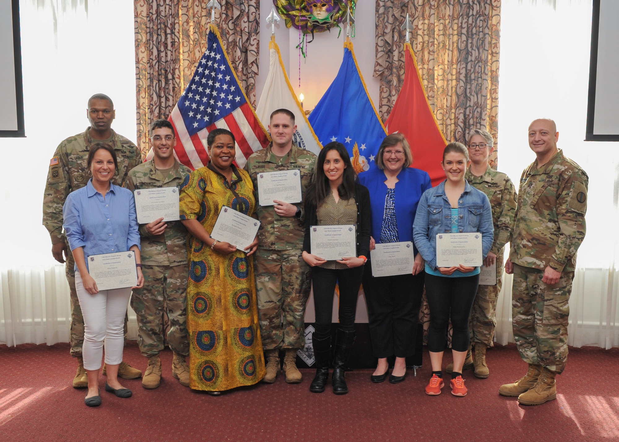 First quarter volunteer award recipients pose for a photo with U.S. Army Maj. Gen. Anthony Funkhouser, Center for Initial Military Training commander, right, and Command Sgt. Maj. Michael Gragg, Center for Initial Military Training command sergeant major, left, during the Volunteer of the Quarter ceremony at Joint Base Langley-Eustis, Va., Feb. 28, 2017.  The volunteers were selected from various agencies on Fort Eustis, including: Outdoor Recreation, Army Community Service, the Spouses' Club, McDonald Army Health Center, and the fitness centers. (U.S. Air Force photo by Tech. Sgt. Katie Gar Ward)