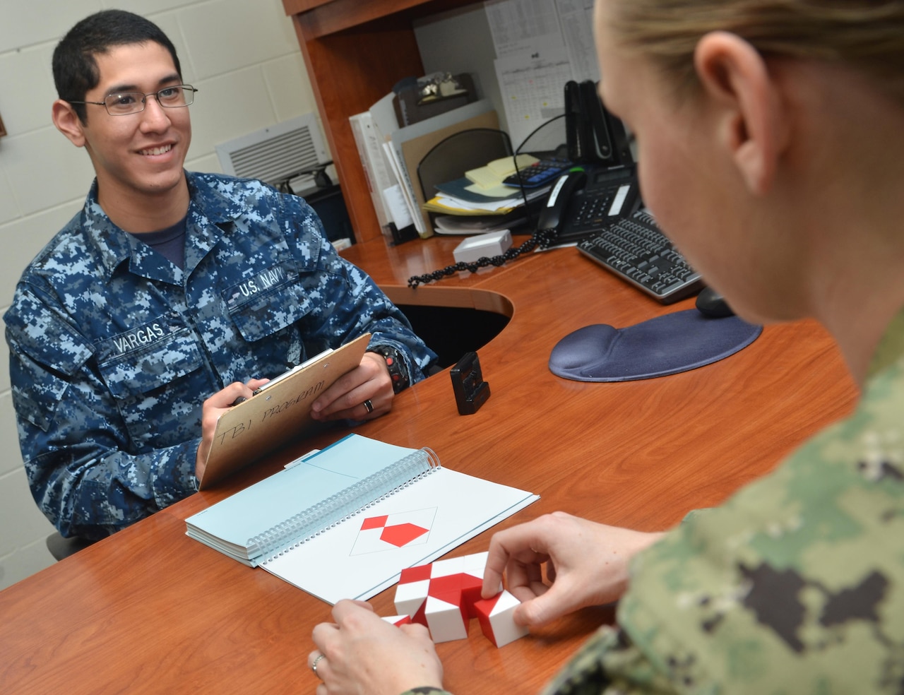 Navy Seaman David Vargas, left, a behavioral health technician, conducts a block design test on a patient to assess functioning of the parietal and frontal lobes at Naval Hospital Jacksonville in Florida, Feb. 1, 2017. March is Brain Injury Awareness Month. Navy photo by Jacob Sippel
