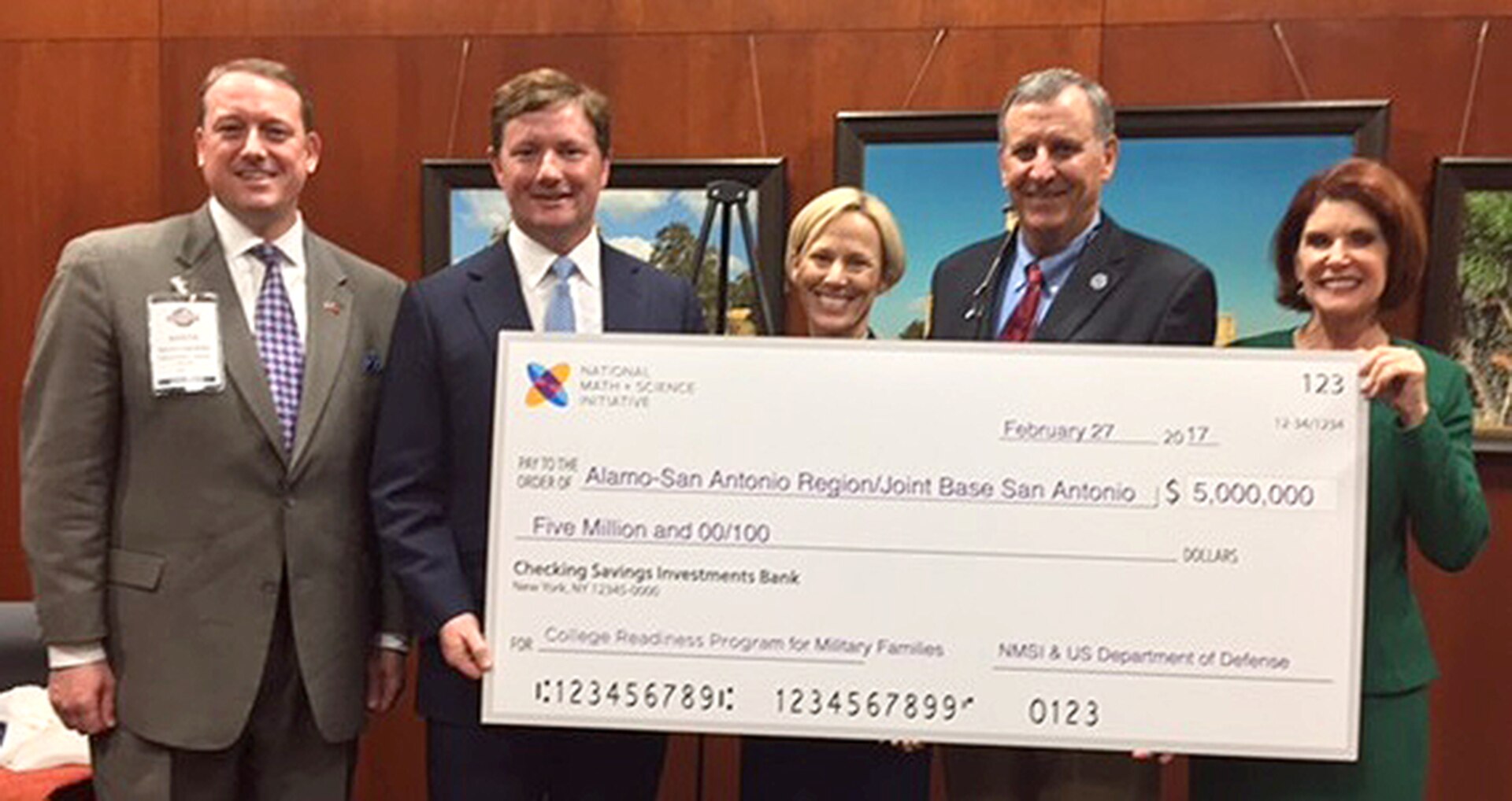 Marcus Ligenfelter, (left) president of the National Math and Science Initiative, or NMSI, presents a $5 million check Feb. 27 earmarked for science, technology, engineering and mathematics, or STEM, education in high schools serving military dependents at Joint Base San Antonio. This is the first round of funding and will be directed to individual school districts within JBSA to incentivize advanced placement classes. This is a Department of Defense-supported initiative to provide the successful model to the military. Also in photo from left are Rad Weaver, San Antonio Chamber of Commerce president; Brig. Gen. Heather Pringle, commander, 502nd Air Base Wing and JBSA; Chris Schuchart, Medina County judge and chair, Alamo Area Council of Government; and Diane Rath, AACOG executive director.