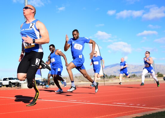 U.S. Air Force Tech. Sgt. Ben Seekell, 2017 AF Trials competitor, sprints to the finish of the 100 meter dash during Track and Field qualifications at the Warrior Fitness Center Feb. 28, 2017 at Nellis Air Force Base, Nev. During a 2011 improvised explosive device attack in Afghanistan, Seekell attributes his survival to the quick action of his teammates. (U.S. Air Force photo by Senior Airman Chip Pons)