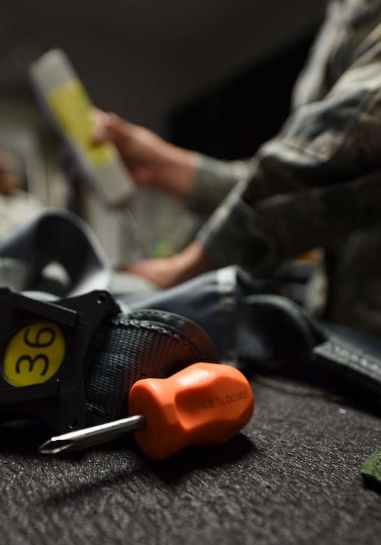 U.S. Air Force Airman 1st Class Femylyn Plan, 1st Operation Support Squadron aircrew flight equipment technician, inspects flight equipment at Joint Base Langley-Eustis, Va., Feb. 27, 2017. The technicians inspect equipment ranging from communication to life-saving gear required for pilots in order to have a successful flight. (U.S. Air Force photo by Staff Sgt. Natasha Stannard)