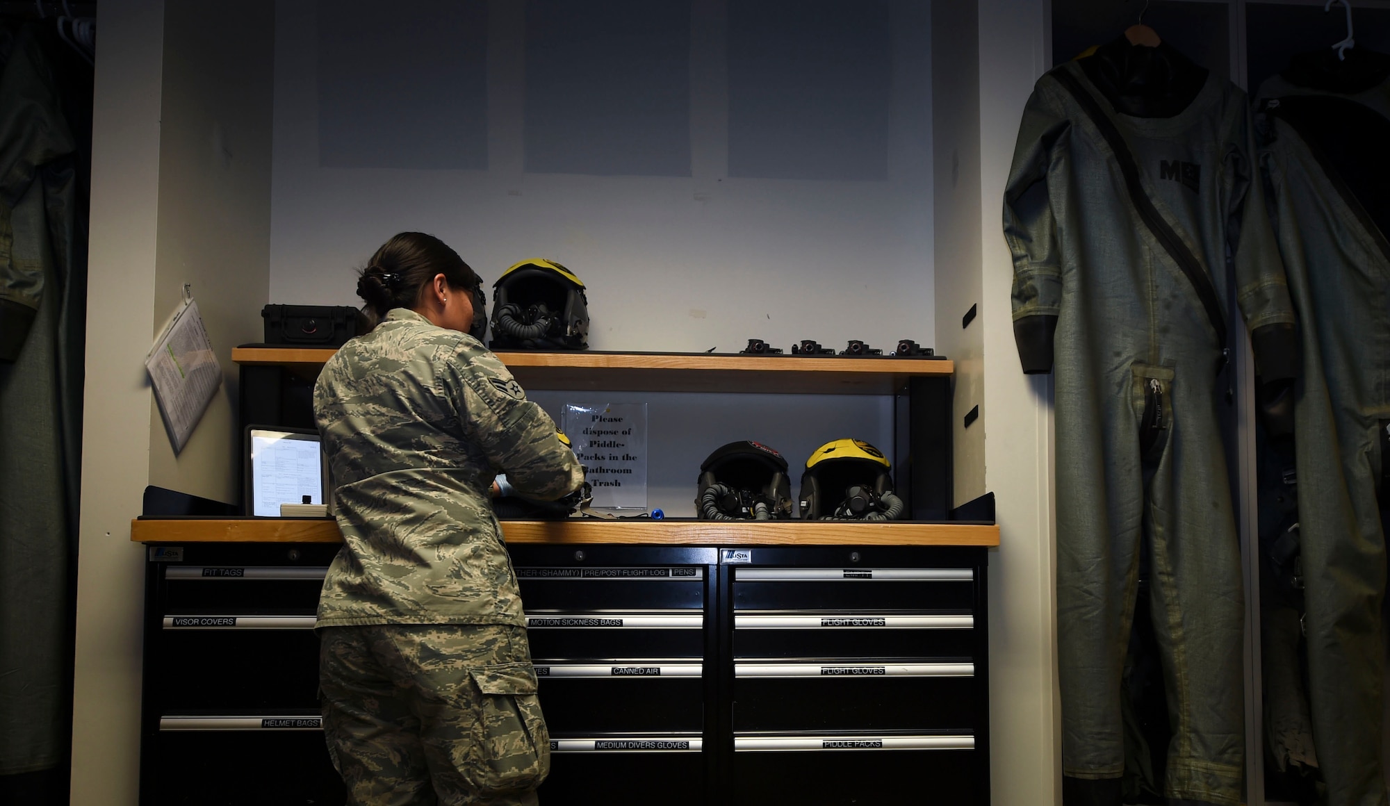 U.S. Air Force Airman 1st Class Femylyn Plan, 1st Operation Support Squadron aircrew flight equipment technician, inspects F-22 Raptor helmets at Joint Base Langley-Eustis, Va., Feb. 27, 2017. The 1st OSS, is a part of the1st Fighter Wing, which flies, maintains and supports one third of the U.S. Air Force’s F-22 Raptor fleet. (U.S. Air Force photo by Staff Sgt. Natasha Stannard)