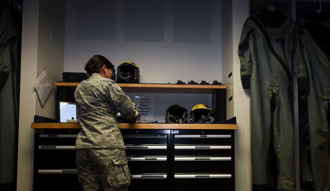 U.S. Air Force Airman 1st Class Femylyn Plan, 1st Operation Support Squadron aircrew flight equipment technician, inspects F-22 Raptor helmets at Joint Base Langley-Eustis, Va., Feb. 27, 2017. The 1st OSS, is a part of the1st Fighter Wing, which flies, maintains and supports one third of the U.S. Air Force’s F-22 Raptor fleet. (U.S. Air Force photo by Staff Sgt. Natasha Stannard)