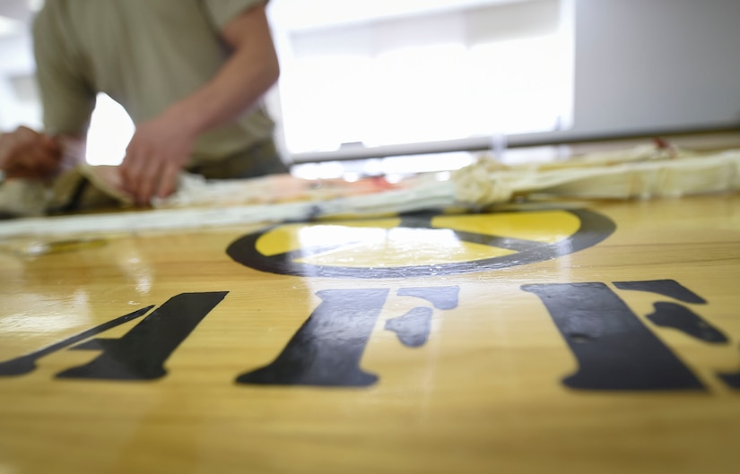 U.S. Air Force Senior Airman Tyler Wineman, 1st Operation Support Squadron aircrew flight equipment technician, rigs a drogue parachute at Joint Base Langley-Eustis, Va., Feb. 27, 2017.  The 1st OSS maintains, repairs and inspects equipment for 1st Fighter Wing aircraft. (U.S. Air Force photo by Staff Sgt. Natasha Stannard)