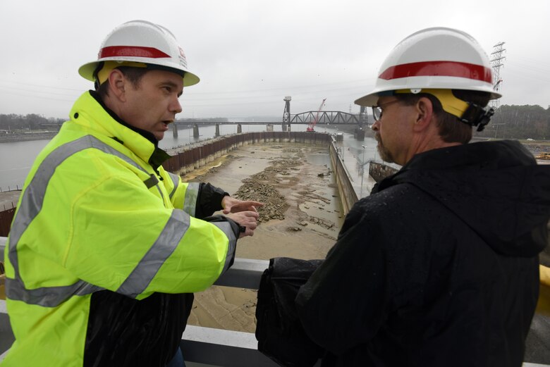 Tommy Long (Left), resident engineer for the Chickamauga Lock Replacement Project, explains how the river bed will be excavated ahead of future construction of the new 110-foot by 600-foot navigation lock to Douglas Lamont, senior official performing duties of secretary of the Army for Civil Works, during his visit to the lock on the Tennessee River in Chattanooga, Tenn., Feb. 28, 2017. 