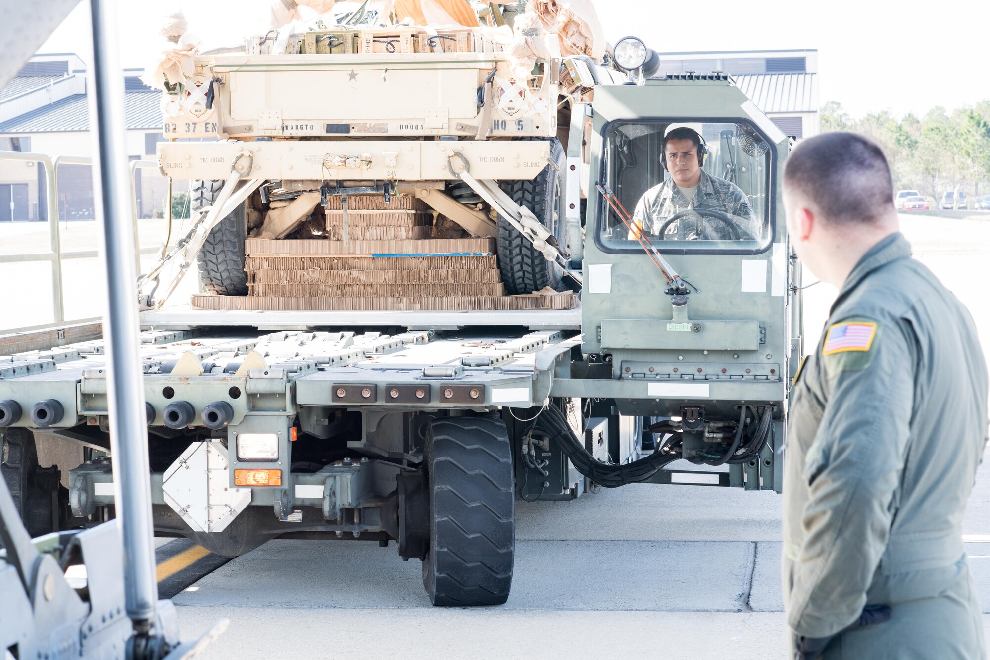 Airman 1st Class Cergio Ramos, 43d Air Mobility Squadron, drives a K-loader toward the rear of a C-130 Hercules from the 19th Airlift Wing at Little Rock Air Force Base, Arkansas, on Green Ramp here Feb. 28. Ramos and other Airmen in the Aerial Port here supported visiting Air Mobility Command aircrews and Soldiers from Fort Bragg during Battalion Mass Tactical Week, held here Feb. 27 through March 2. (U.S. Air Force photo/Marc Barnes)