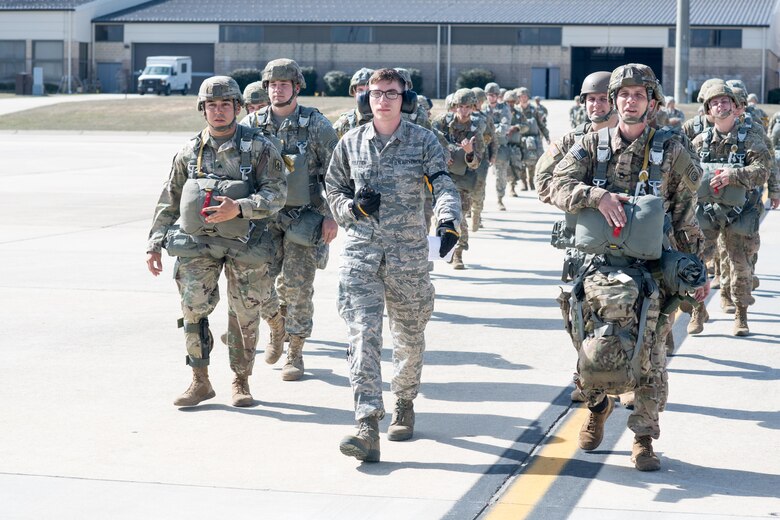 Airman 1st Class Patric Vuletich, a 43d Air Mobility Squadron Aerial Port passenger service agent, escorts nearly 60 U.S. Army paratroopers to a C-130 Hercules from the 317th Airlift Wing at Dyess Air Force Base, Texas, on Green Ramp here Feb. 28. Vuletich and numerous other Airmen from the 43d Air Mobility Operations Group supported visiting Air Mobility Command aircrews and Soldiers from Fort Bragg during Battalion Mass Tactical Week, held here Feb. 27 through March 2. (U.S. Air Force photo/Marc Barnes)
