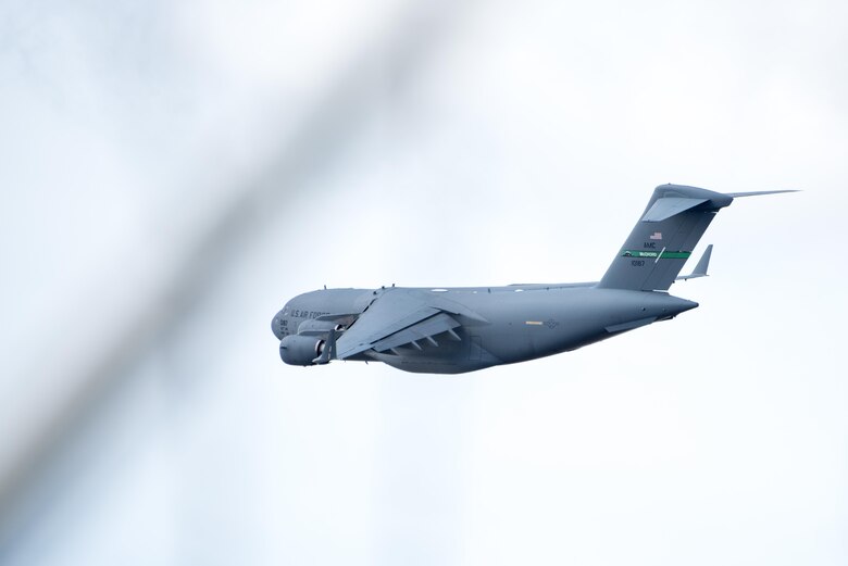 A C-17 Globemaster III from the 62nd Airlift Wing at Joint Base Lewis-McChord flies over Pope Army Airfield with a load of 82nd Airborne Division paratroopers after taking off during Battalion Mass Tactical Week, held here Feb. 27 through March 2. Airmen in the 43d Air Mobility Operations Group here provided support for visiting Air Mobility Command aircrews from Joint Base Lewis-McChord and other AMC units, and for Fort Bragg Soldiers during the joint training exercise. (U.S. Air Force photo/Marc Barnes)