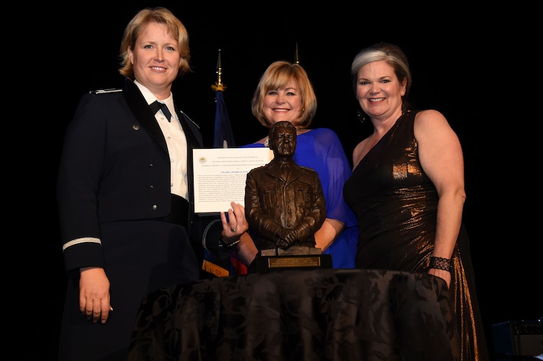 Col. DeAnna Burt, 50th Space Wing commander, receives the Gen. Jerome F. O'Malley Distinguished Space Leadership Award from Lance P. Sijan Chapter president, Kristen Christy, (right) and Gen. O’Malley’s daughter, Sharon O’Malley-Burg, during an Air Force Ball in Colorado Springs, Colo., Friday Feb. 25, 2017. The award is given to those who demonstrate outstanding leadership in ‘delivering space capabilities to support national objectives and integrating space effects into combat operations.’ (U.S. Air Force photo/Senior Airman Arielle Vasquez)