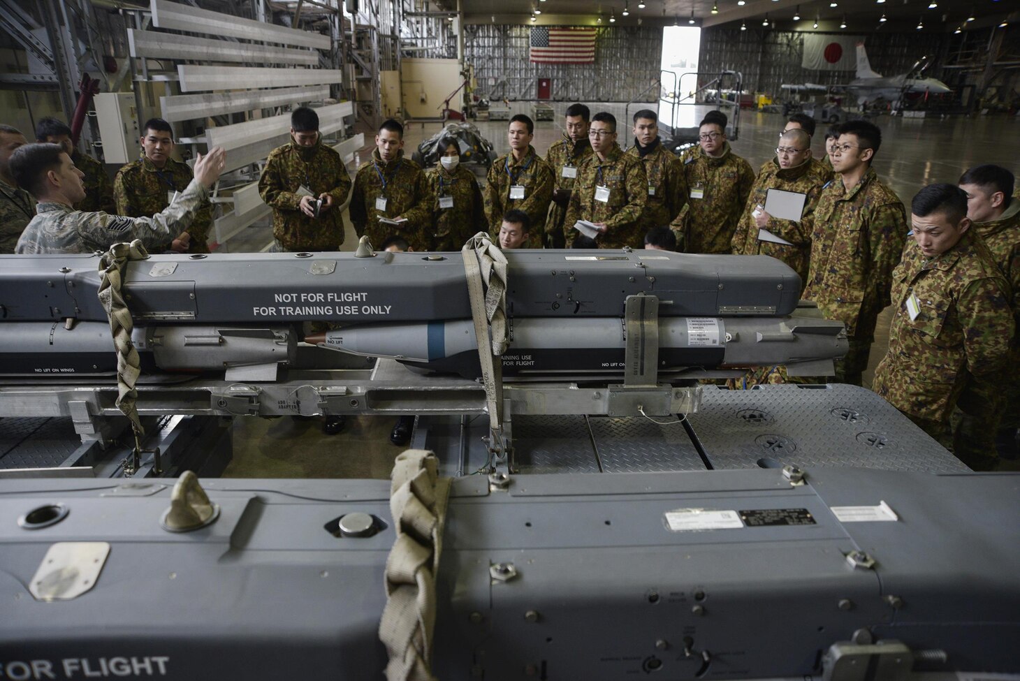 U.S. Air Force Tech. Sgt. Nathan Monica, left, a lead standardization crew member with the 35th Maintenance Group, describes the variety of munitions locally stored to Japan Ground Self-Defense Force soldiers at Misawa Air Base, Japan, Feb. 23, 2017. The 35th MXG was one of several stops on their three-day tour. The JGSDF soldiers learned about the different warfighter capabilities of the F-16 Fighting Falcon.