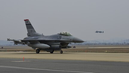 An F-16 Fighting Falcon assigned to the 36th Fighter Squadron taxis to the runway for a training mission while an A-10 Thunderbolt II from the 25th Fighter Squadron takes off during Exercise Beverly Herd 17-1 at Osan Air Base, Republic of Korea, March 1, 2017. Pilots from both fighter squadrons flew multiple sorties during exercise Beverly Herd, honing their flying skills and ability to work around the rugged ROK landscape. 