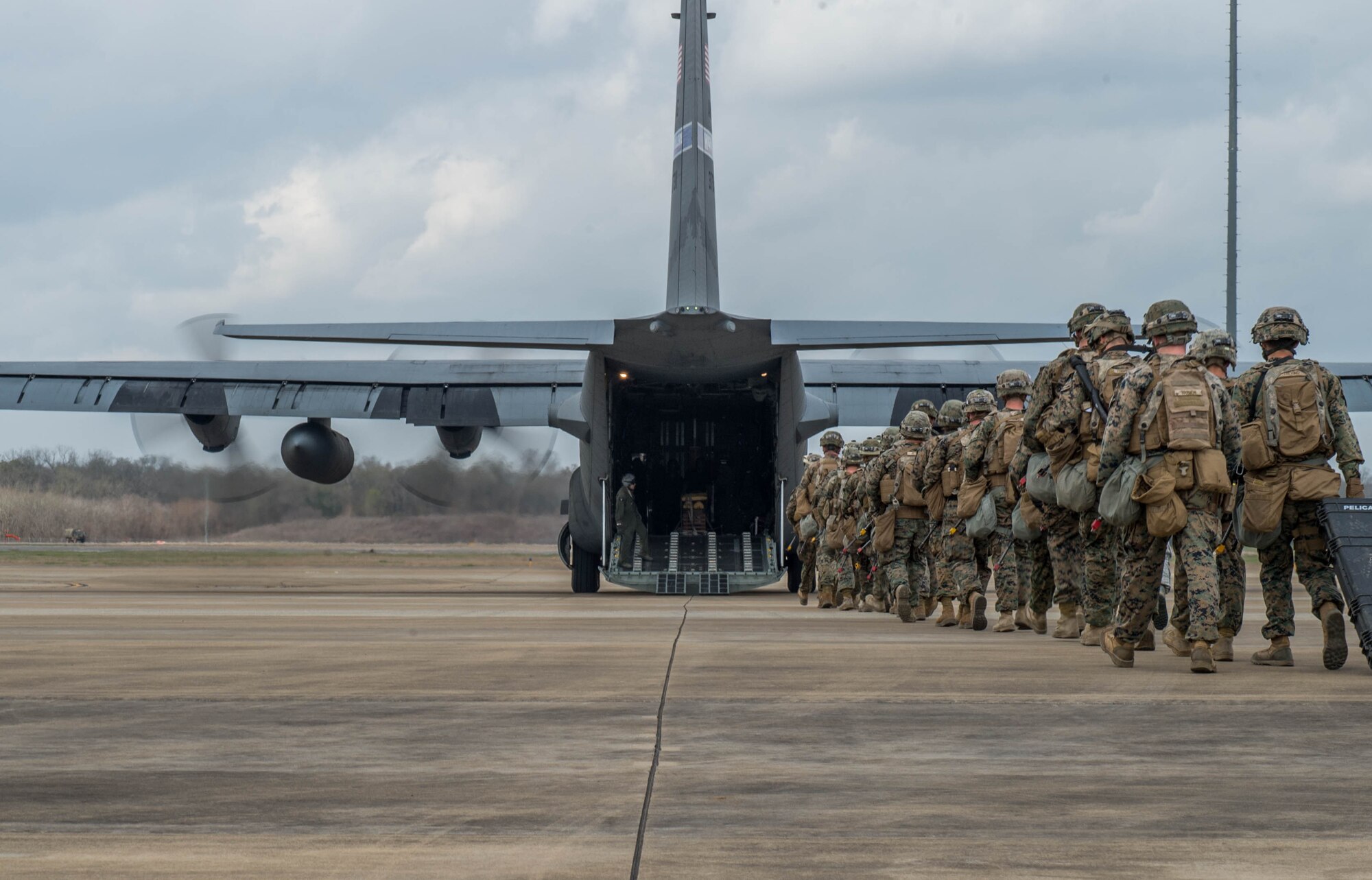 Marines prepare to board a C-130J Super Hercules during a Joint Readiness Training exercise, Feb. 12, 2016, at Alexandria International Airport, LA. Throughout the exercise the aerial port team loaded and offloaded 101 C-130 Super Hercules and 21 C-17 Globemaster III aircraft and moved 282 short tons of cargo during the exercises, as well as supporting the movement of more than 670 passengers. (U.S. Air Force photo by Staff Sgt. Robert Hicks) 