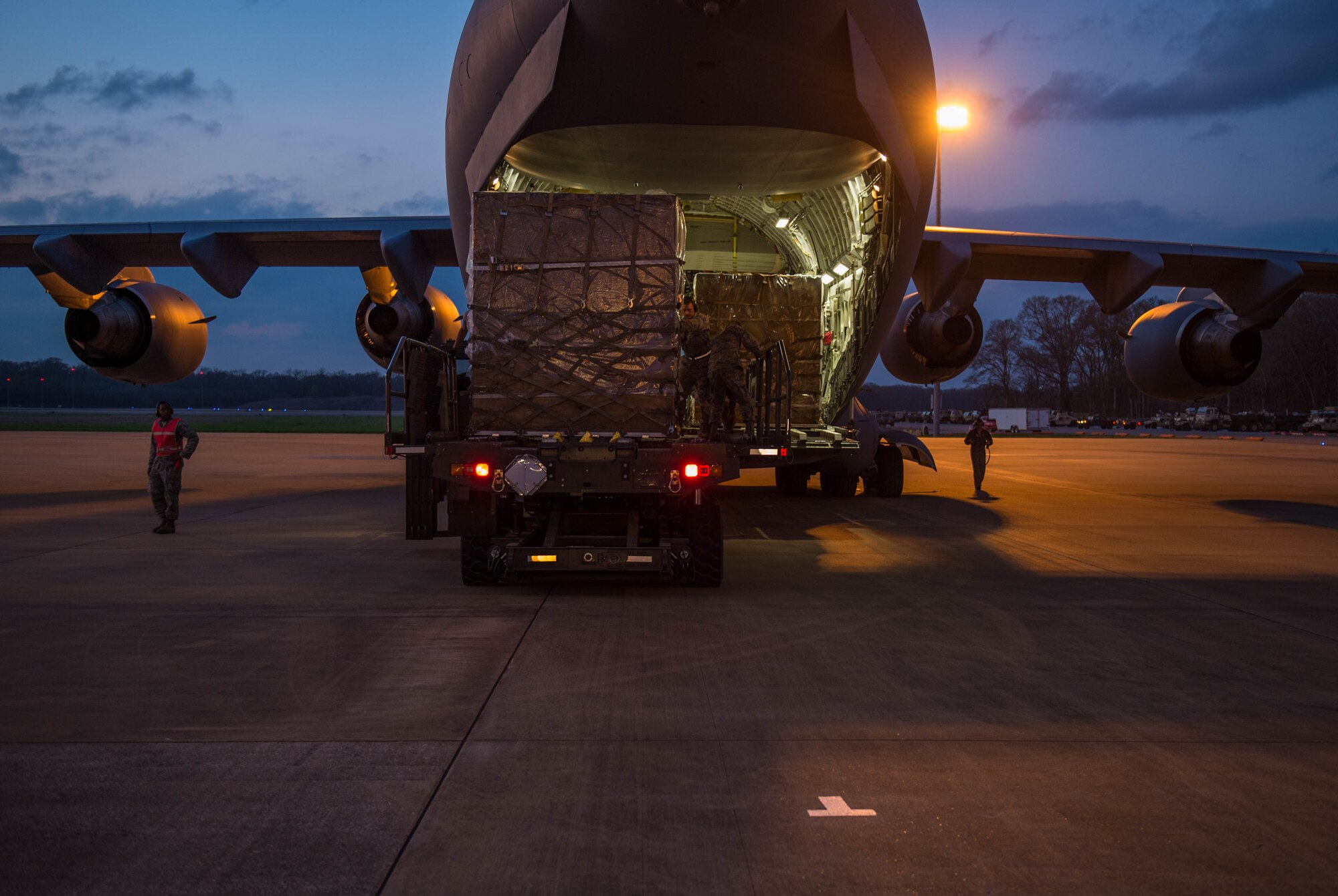 Airmen from the 621st Contingency Response Wing, offload cargo from a C-17 Globemaster III aircraft using a K-loader, during a Joint Readiness Training exercise, Feb. 12, 2016, at Alexandria International Airport, LA. Throughout the exercise the aerial port team loaded and offloaded 101 C-130 Super Hercules and 21 C-17 Globemaster III aircraft and moved 282 short tons of cargo during the exercises, as well as supporting the movement of more than 670 passengers. (U.S. Air Force photo by Staff Sgt. Robert Hicks)
