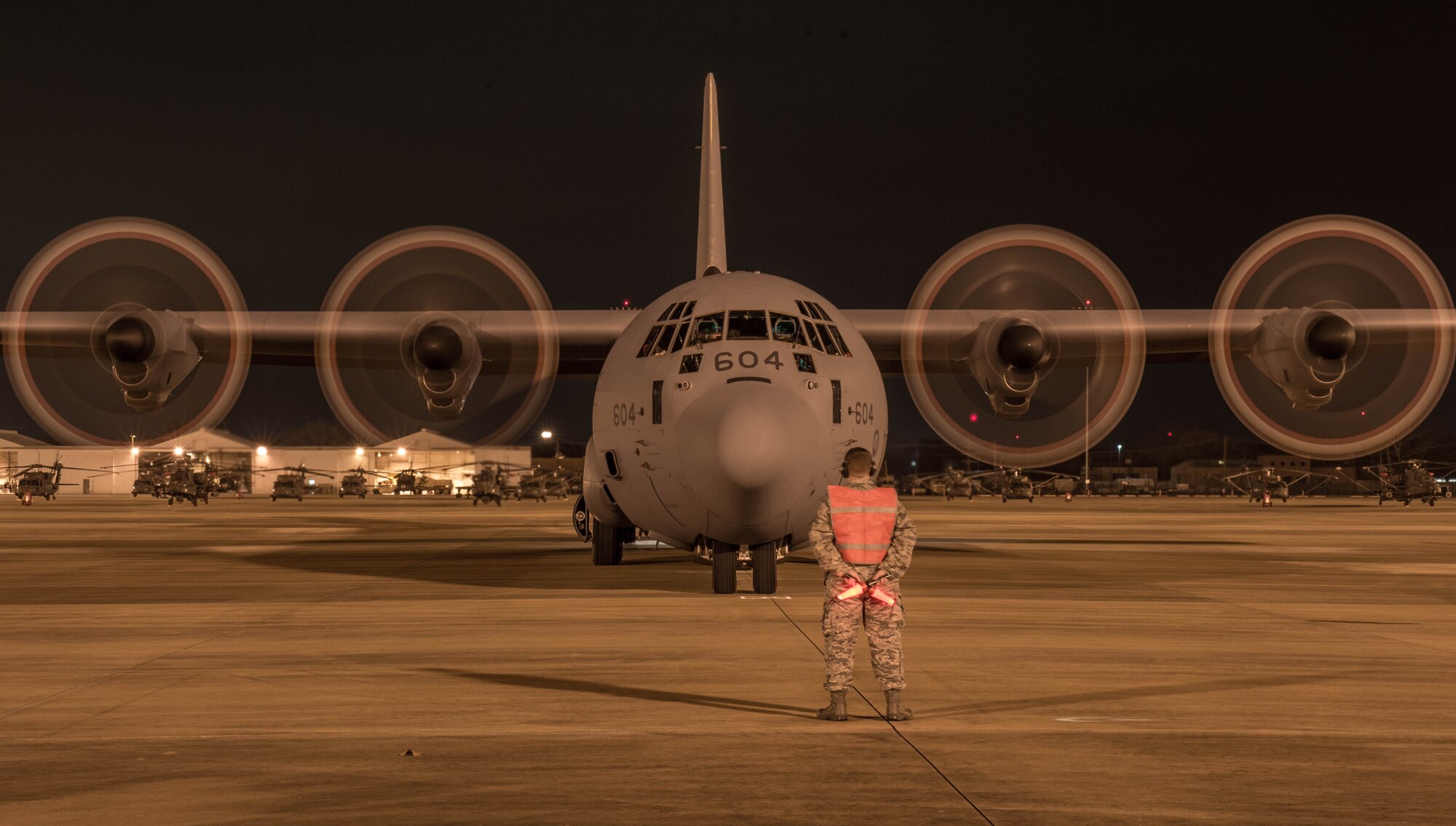 U.S. Air Force Staff Sgt. Justin Fraissinet, 821st Contingency Response Squadron maintainer, prepares to marshal a Royal Canadian Air Force C-130J Super Hercules aircraft during a Joint Readiness Training exercise, Feb. 11, 2016, at Alexandria International Airport, LA. Throughout the exercise the aerial port team loaded and offloaded 101 C-130 Super Hercules and 21 C-17 Globemaster III aircraft and moved 282 short tons of cargo during the exercises, as well as supporting the movement of more than 670 passengers. (U.S. Air Force photo by Staff Sgt. Robert Hicks)