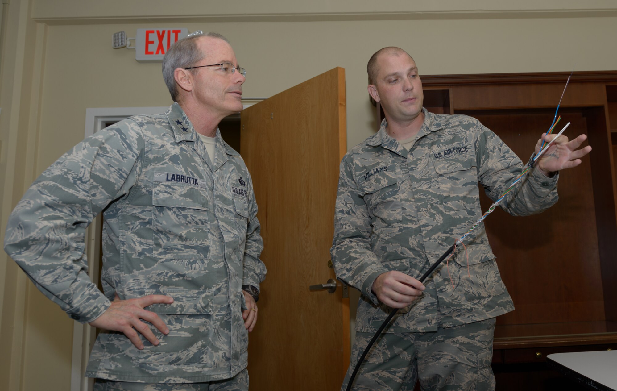 Senior Airman Micheal Turland, 85th Engineering Installation Squadron cable and antenna systems technician, explains opening up fiber optic cable to Maj. Gen. Robert LaBrutta, 2nd Air Force commander, during a 2nd AF immersion tour of the unit located at Keesler Air Force Base, Miss., Feb. 9, 2017. The Airmen at the 85th EIS are part of the only active duty EIS in the Air Force. They are also the only organization in the Defense Department providing specialized engineering services such as electromagnetic hazard and interference investigations and High Altitude Electromagnetic Pulse protection. (U.S. Air Force photo by Andre’ Askew)
