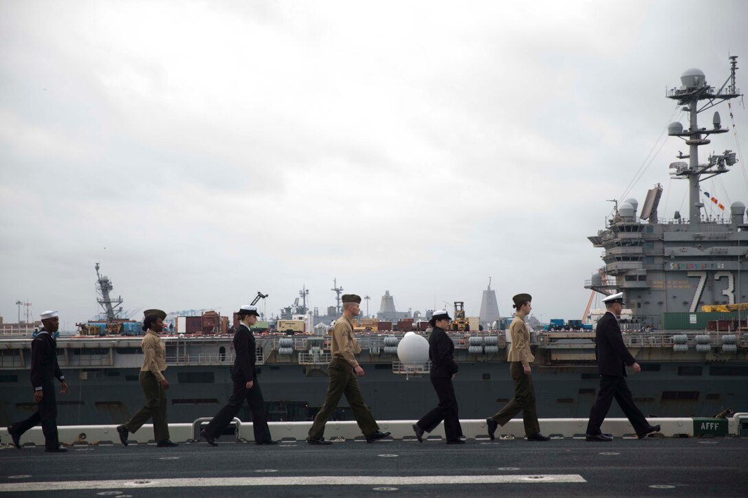 Marines and sailors with the 24th Marine Expeditionary Unit man the rails as amphibious assault ship USS Bataan (LHD 5) prepares to go underway for deployment March 1, 2017. The 24th MEU will operate in Europe and the Middle East in the coming months providing crisis response and contingency support for combatant commanders, including maritime security operations, humanitarian assistance, and advance force operations. (U.S. Marine Corps photo by Lance Cpl. Autmn Bobby)