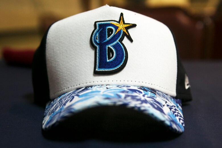 AYokohama DeNA BayStars hat sits on a table Feb. 24 at the Habu Pit on Marine Corps Air Station Futenma, Okinawa, Japan. The Yokohama DeNA BayStars baseball team had the chance to tour an MV-22B Osprey and visit with Marines while on MCAS Futenma. “Events like this enhance the already strong community relations MCAS Futenma enjoys with the surrounding City of Ginowan,” said Lt. Col. Bob Sweginnis, the executive officer of MCAS Futenma. “This event in particular allowed those who live and work aboard MCAS Futenma to meet and interact with professional baseball players from a prominent Japanese Big League team that conducts spring training every year in here Ginowan City, just outside the gates of Futenma.” (U.S. Marine Corps Photo by Cpl. Jessica Collins)