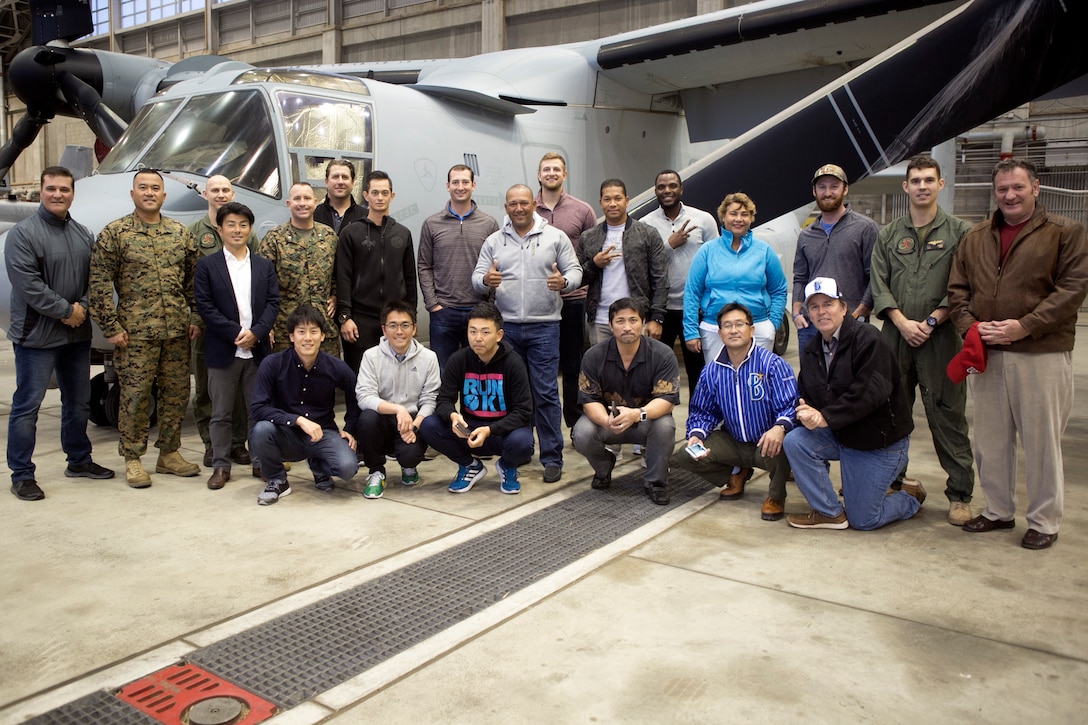 Marines and Yokohama DeNA BayStars baseball team pose in front of an MV-22B Osprey Feb. 23 on Marine Corps Air Station Futenma, Okinawa, Japan. The BayStars players and staff had the opportunity to tour an Osprey and dine at the Habu Pit. “Events like this enhance the already strong community relations MCAS Futenma enjoys with the surrounding City of Ginowan,” said Lt. Col. Bob Sweginnis, the executive officer of MCAS Futenma. “This event in particular allowed those who live and work aboard MCAS Futenma to meet and interact with professional baseball players from a prominent Japanese Big League team that conducts spring training every year in here Ginowan City, just outside the gates of Futenma.”  (U.S. Marine Corps Photo by Cpl. Jessica Collins)