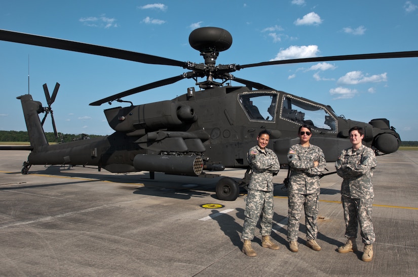 1st Lt. Jenna Pitcher and Staff Sgt. Lauren Rhodes assist U.S. Army Chief Warrant Officer Deborah Glenn, Company B, 1-151st Attack and Reconnaissance Battalion, South Carolina Army National Guard, on a AH-64D Apache helicopter at McEntire Joint National Guard Base in Eastover, S.C., Aug. 4, 2015.