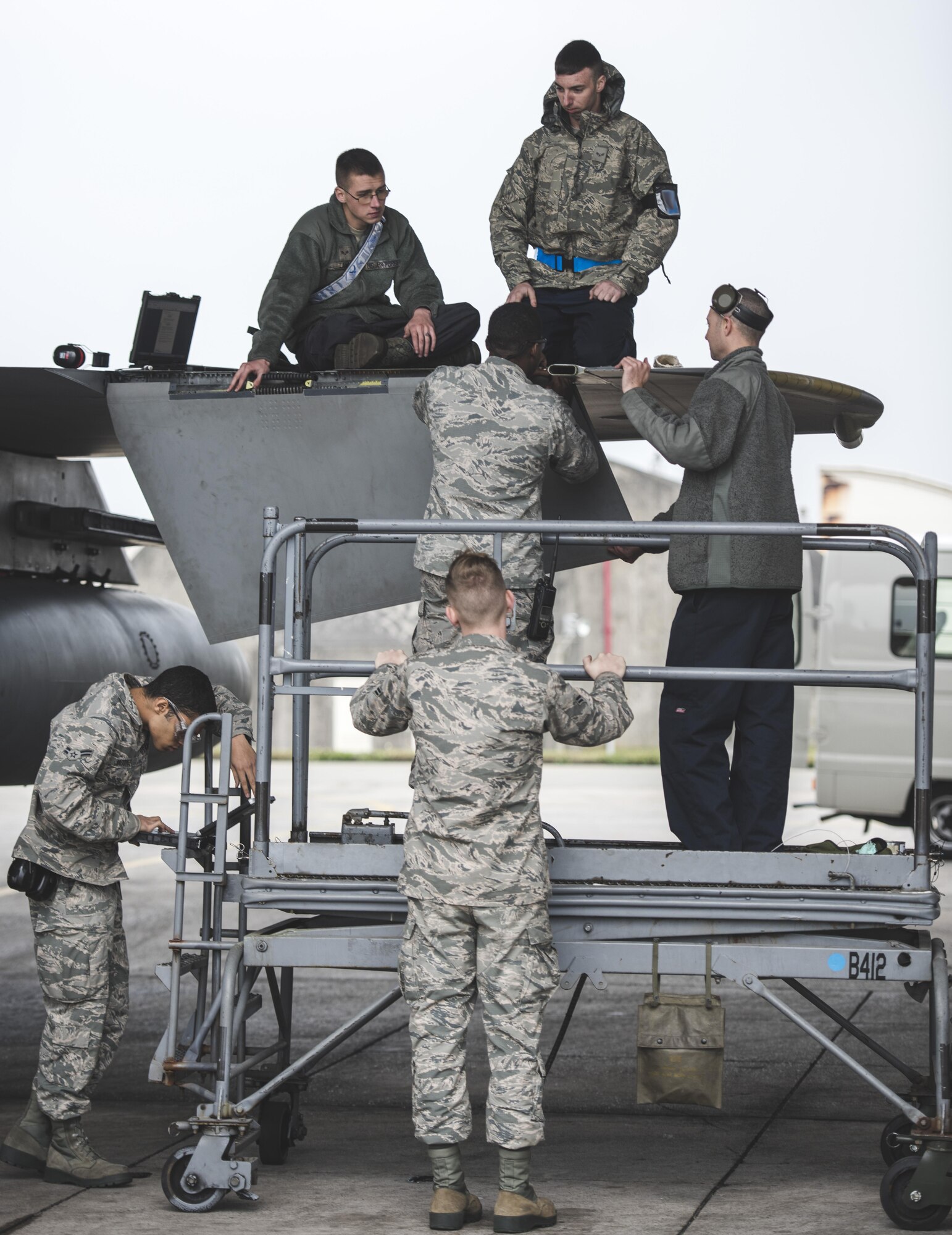 Aircraft maintainers from the 18th Maintenance Squadron replace the fuel dump mast on an F-15C Eagle Mar. 2, 2017, at Kadena Air Base, Japan. The fuel dump was taken apart, repaired and replaced in a team effort by crew chiefs, sheet metal and fuels systems technicians. (U.S. Air Force photo by Senior Airman Omari Bernard/Released)