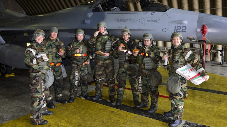 Airmen assigned to the 51st Aircraft Maintenance Squadron pose with chaplains from the 51st Fighter Wing during Exercise Beverly Herd 17-1 at Osan Air Base, Republic of Korea, March 2, 2017. Members of the chapel staff conducted morale visits across base during the exercise, usually with food and drink readily available for the Airmen they would speak with. (U.S. Air Force photo by Staff Sgt. Victor J. Caputo)