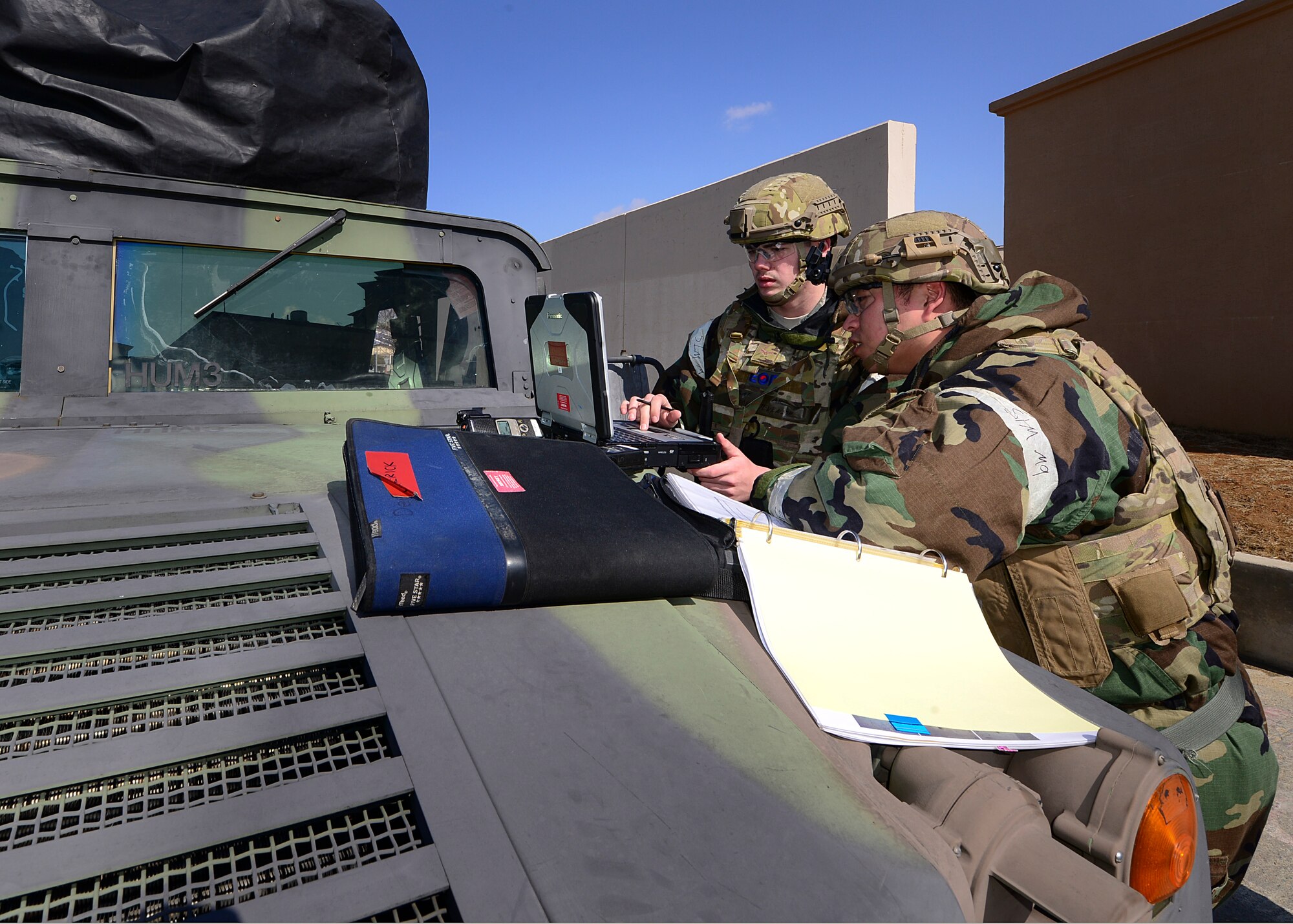 U.S. Air Force Staff Sgt. Alex Gaunt (right), 51st Civil Engineer Squadron explosive ordnance disposal sergeant and Airman 1st Class Cody Stevenson(left), 51st CES explosive ordnance disposal apprentice discuss proper ways to dispose and remove an unexploded ordinance from a simulated patient’s abdomen during Exercise Beverly Herd 17-1 at Osan Air Base, Republic of Korea, March 2, 2017. The scenario was based off of a real-world situation that happened in the Middle East, painting a realistic picture of war that highlighted the importance of being prepared and ready to “Fight Tonight.” (U.S. Air Force photo by Airman Gwendalyn Smith)