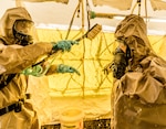 A New York City Police officer assigned to the NYPD's  Chemical Ordnance, Biological and Radiological Awareness (COBRA) unit goes through decontamination during a joint exercise with New York Army National Guard Soldiers of the 222nd Chemical Company, based at Fort Hamilton, Brooklyn, N.Y. at the NYPD's Rodman's Neck Tactical Village in the Bronx, N.Y., on Saturday  Nov. 19, 2016.The National Guard Soldiers and the members of the places of the COBRA  Training Unit used the exercise to share techniques and procedures, and enhance readiness in case of a disaster or terrorist attack. 
