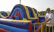 Senior Airman Michael Steelman, a structural craftsman with the 557th Expeditionary RED HORSE Squadron, supervises students playing on an inflatable slide at the American School of Doha, Qatar, Feb. 24, 2017. This slide and many others like it were set up for the annual ASD 2017 Friendship Festival that Airmen from Al Udeid Air Base volunteered at.  (U.S. Air Force photo by Senior Airman Cynthia A. Innocenti)
