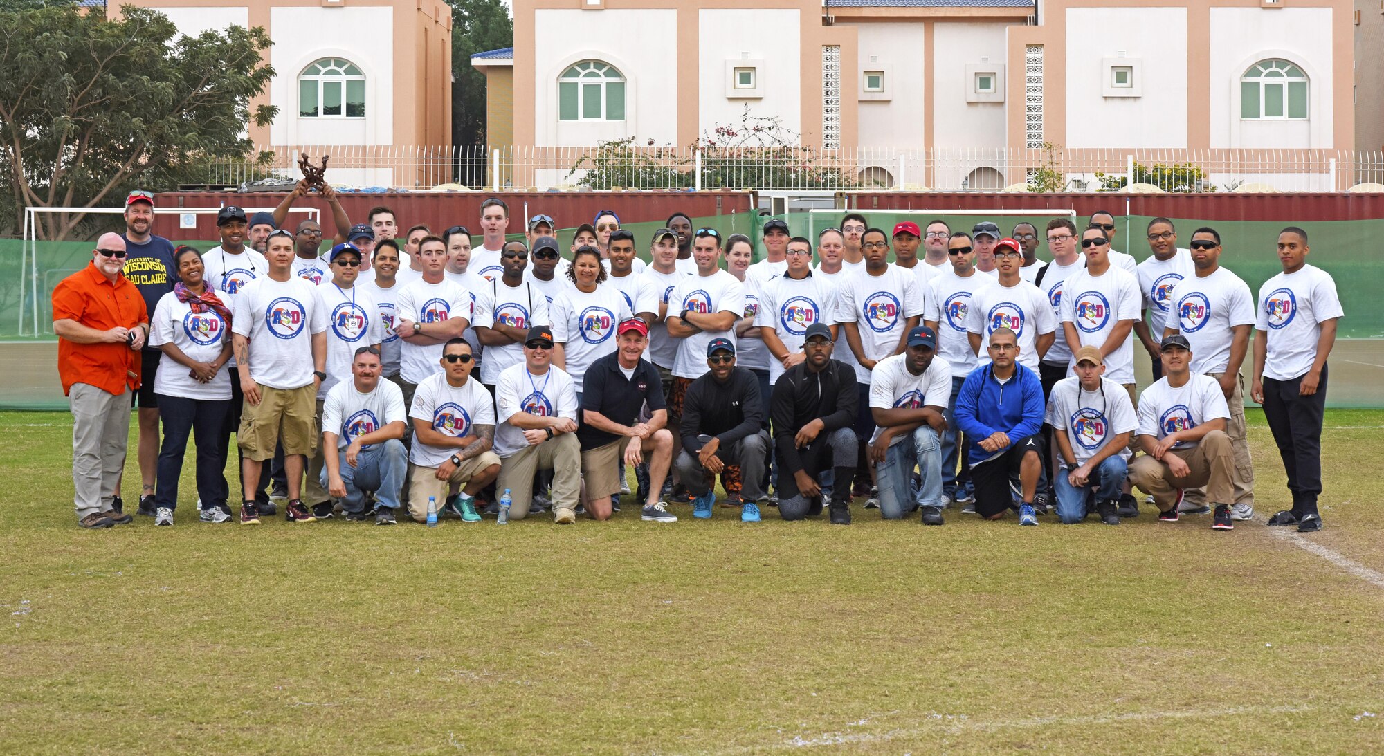 U.S. Airmen from Al Udeid Air Base, Qatar, pose for a photo at the American School of Doha, Feb. 24, 2017. Airmen volunteered to help set up, organize and run games, as well as provide adult supervision during the annual ASD 2017 Friendship Festival. (U.S. Air Force photo by Senior Airman Cynthia A. Innocenti)