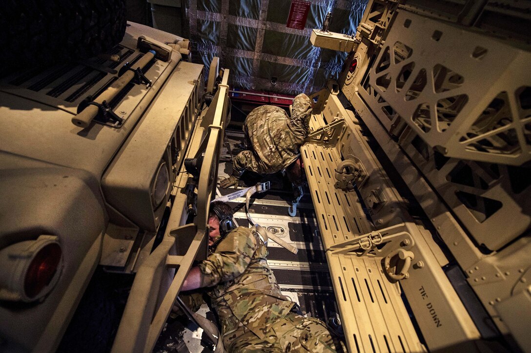 Airmen strap down Humvees inside an MC-130J Commmando II aircraft during Emerald Warrior 17 at Hurlburt Field, Fla., Feb. 28, 2017. The airmen are loadmasters assigned to the 9th Special Operations Squadron. Air Force photo by Staff Sgt. Corey Hook 