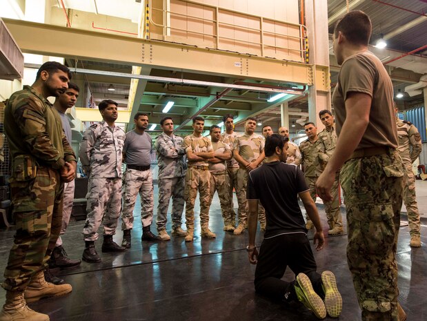 U.S. Coast Guard Petty Officer 3rd Class Michael Black, maritime enforcement specialists assigned to the Maritime Engagement Team (MET), exchanges skills and tactics with members from the Iraq and Pakistan navy at Naval Support Activity Bahrain, Feb. 28th. The USCG MET is responsible for providing specialized law enforcement exercises with foreign military units around the region.  