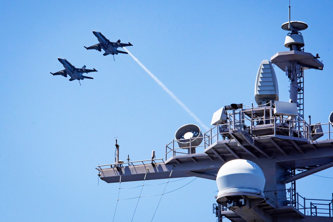 Two F/A-18E Super Hornet aircraft fly over the aircraft carrier USS Carl Vinson in the South China Sea, Feb. 22, 2017. The pilots are assigned to Strike Fighter Squadron 137. Navy photo by Petty Officer 2nd Class Sean M. Castellano