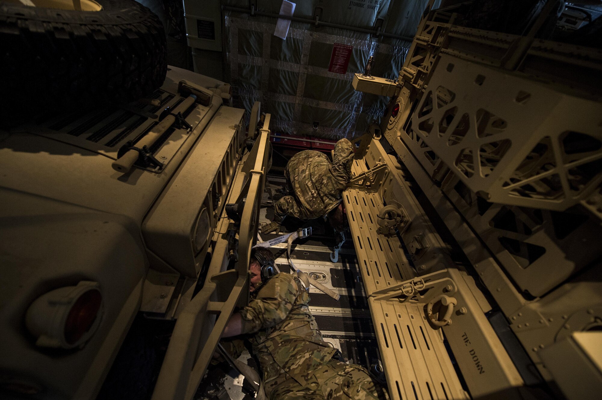 U.S. Air Force 9th Special Operations Squadron loadmasters strap down Humvees inside an MC-130J Commmando II during Exercise Emerald Warrior 17 at Hurlburt Field, Fla., Feb. 28, 2017. Emerald Warrior is a U.S. Special Operations Command exercise during which joint special operations forces train to respond to various threats across the spectrum of conflict. (U.S. Air Force photo by Staff Sgt. Corey Hook)