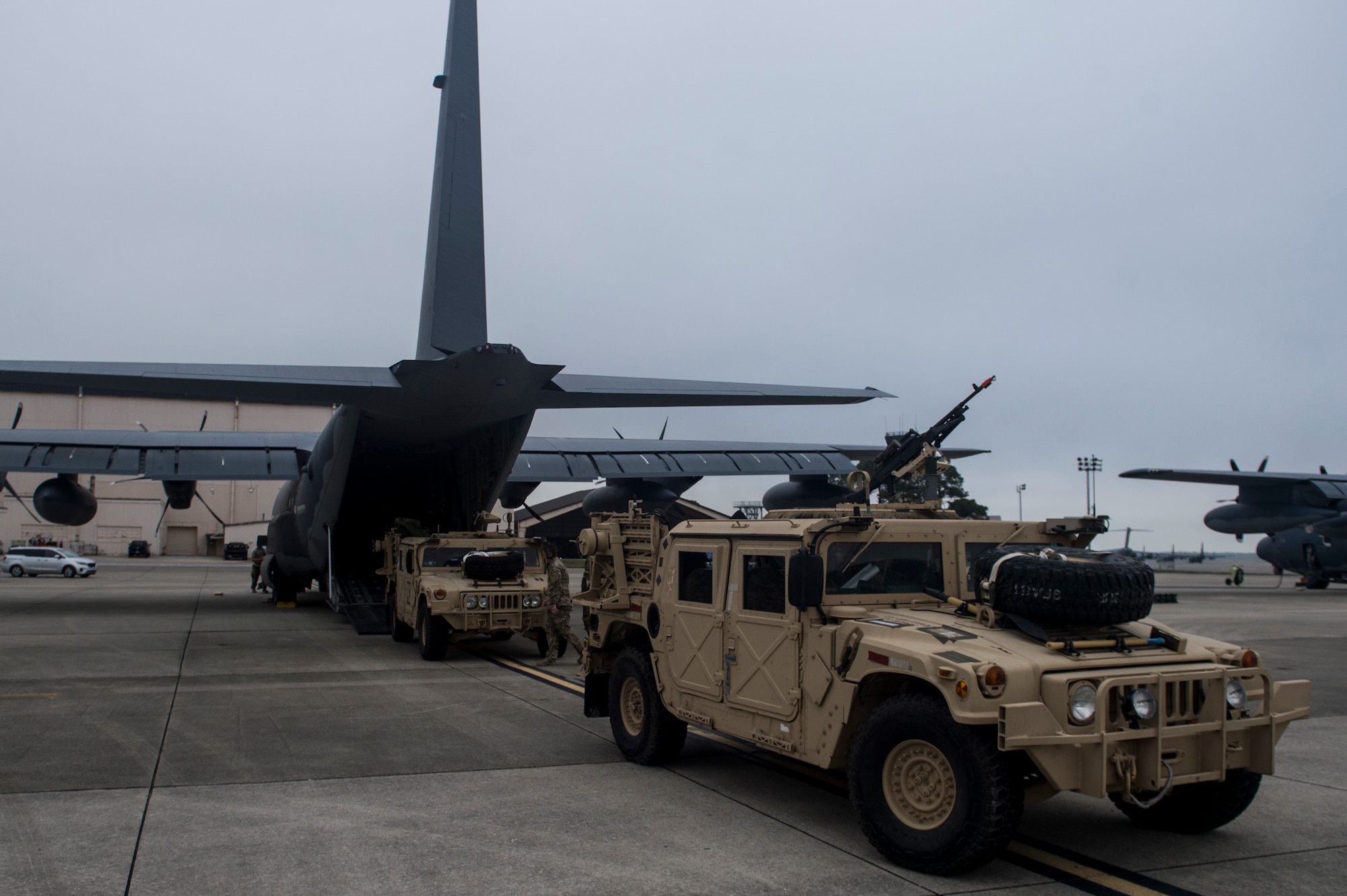 Two Humvees are loaded into a U.S.  Air Force MC-130J Commmando II during Exercise Emerald Warrior 17 at Hurlburt Field, Fla., Feb. 28, 2017. Emerald Warrior is a U.S. Special Operations Command exercise during which joint special operations forces train to respond to various threats across the spectrum of conflict. (U.S. Air Force photo by Staff Sgt. Corey Hook)