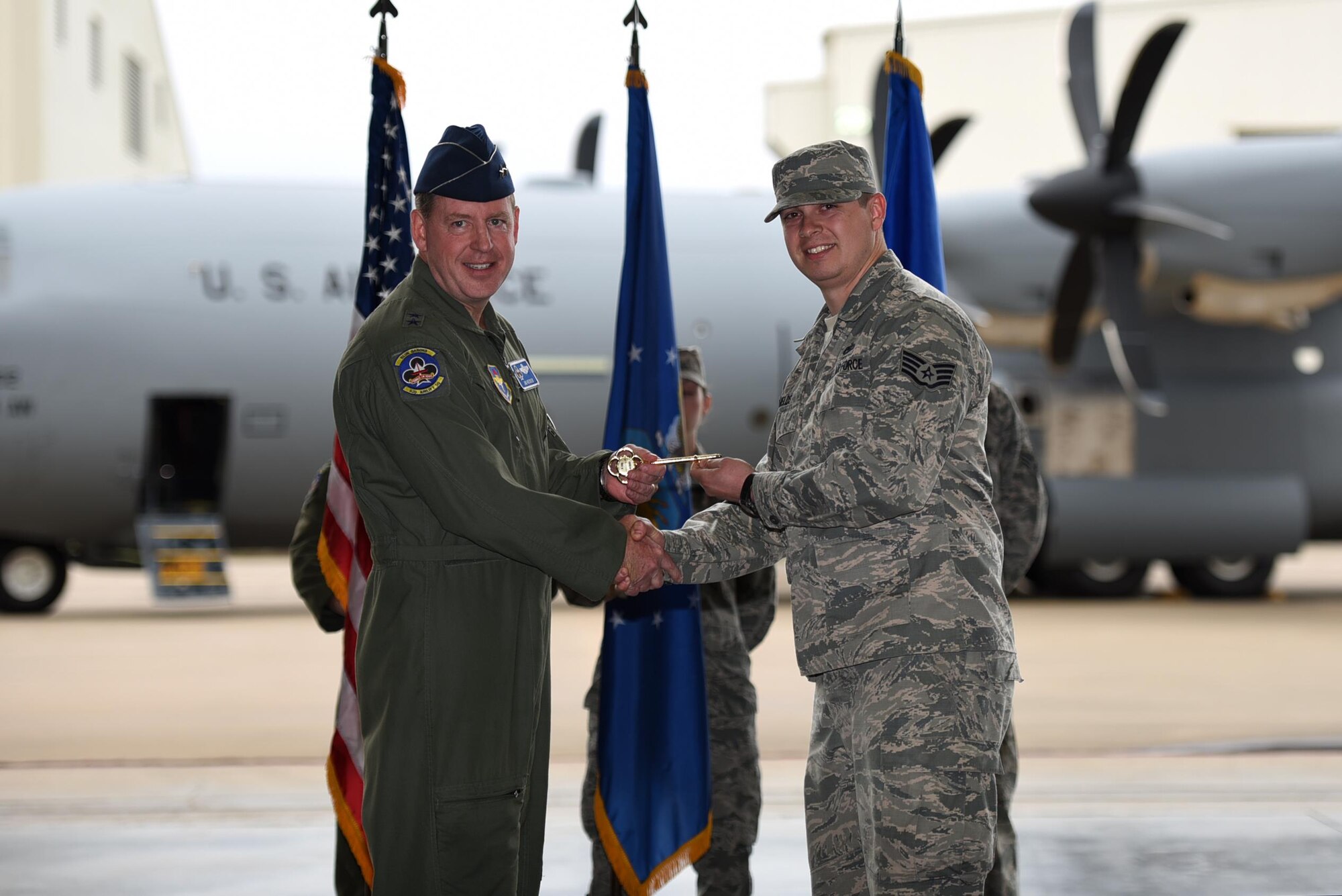 U.S. Air Force Maj. Gen. James Hecker, 19th Air Force commander, presents a ceremonial C-130J key to U.S. Air Force Staff Sgt. Joshua Shields, 314th Aircraft Maintenance Squadron C-130J crew chief, Feb. 27, 2017, at Little Rock Air Force Base, Ark. Hecker delivered the 14th and final C-130J to the 314th Airlift Wing fleet, completing the transition from the H- to J-model. (U.S. Air Force photo by Airman 1st Class Kevin Sommer Giron)