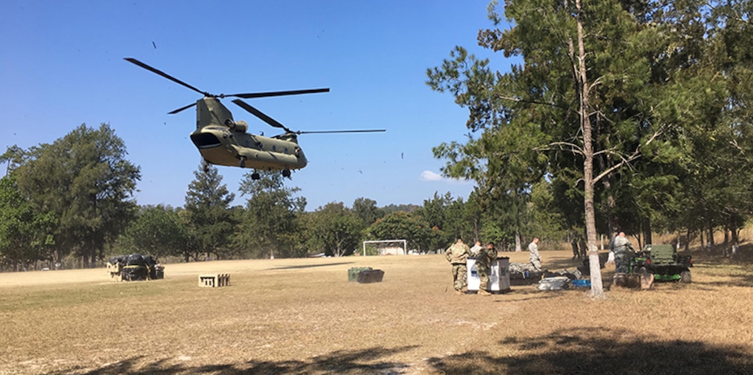 A CH-47 Chinook helicopter from JTF-Bravo's 1st Battalion, 228 Aviation Regiment unloads a pallet of equipment and supplies during a deployment readiness exercise of the U.S. Southern Command Situational Assessment Team (SSAT) in Zambrano, Honduras, Feb. 21 through 23. The SSAT is a quick-reaction deployable team comprised of experts that provide the commander of USSOUTHCOM an immediate assessment of conditions and unique Department of Defense requirements which might be needed during a Humanitarian Assistance, Disaster Response event within the Central American Area of Responsibility. (JTF-Bravo photo)