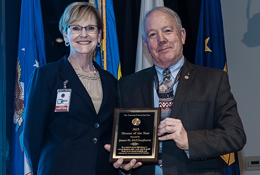 Kathy Drahosz, president of The Training Connection, Inc., presented DLA Land and Maritime Deputy Director James McClaugherty with their Mentor of the Year Award.  
