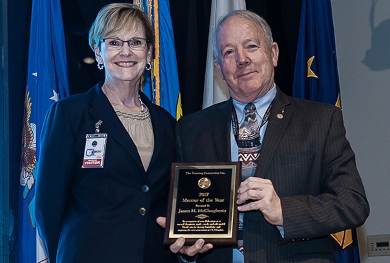Kathy Drahosz, president of The Training Connection, Inc., presented DLA Land and Maritime Deputy Director James McClaugherty with their Mentor of the Year Award.  