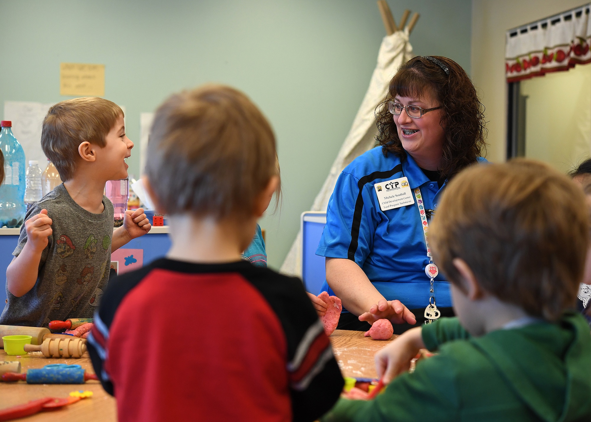 Michele Southall, Grand Forks Air Force Base Child Development Center lead program technician, right, and KJ Gilbert, 4, laugh together Feb. 28, 2017, on Grand Forks AFB, N.D. Southall taught the children how to make playdough and how to play creatively. (U.S. Air Force photo by Senior Airman Ryan Sparks)